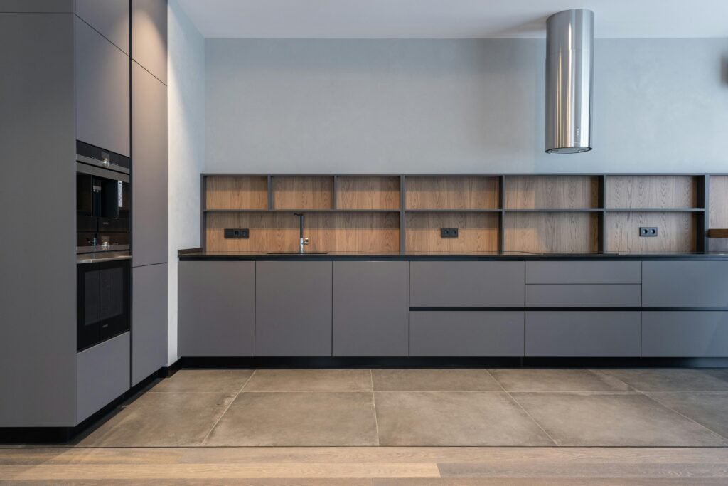 裝潢後清潔 Spacious and sleek modern kitchen with minimalist gray cabinets and efficient layout.