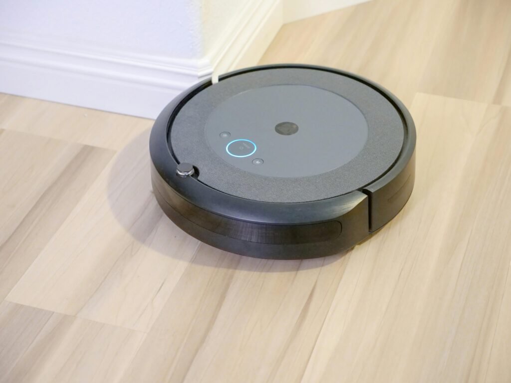 A sleek, modern robotic vacuum cleaner efficiently operating on a hardwood floor.
