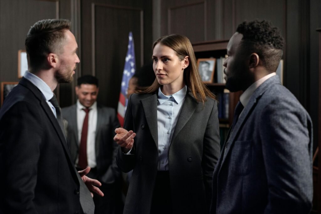 A diverse group of business professionals engaged in a discussion in an office.